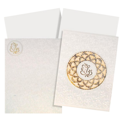 This wedding card is a designer card with a pristine white shading. This card has flower theme all around it in white shading. A Ganesha is placed at the centre with gold foiling laser cut flower design surrounding it. This wedding card has a fold-able single insert with a box type cover. The insert can be made into two inserts if needed. Make your wedding awesome with this card. Get in touch with us to know more.