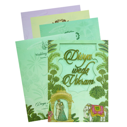 Green Laser-cut Bride &amp; Groom Wedding Card featuring beautiful bride and groom caricature, laser-cut design on MDF board, elephant and plants all around. It also includes gold foiling, 3 inserts and an envelope. Shop now! ?WhatsApp Support ?Express Delivery.