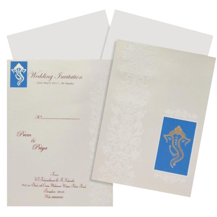 SellingWhite embossed design blue gold ganesha invitation card online. Buying invitation cards made easy with King of Cards! &amp;
